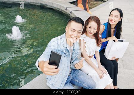 Man taking selfie with friends Stock Photo
