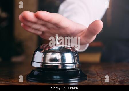 Restaurant bell vintage with hand. Hotel service bell Stock Photo