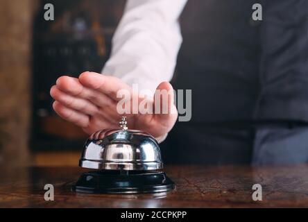 Restaurant bell vintage with hand. Hotel service bell Stock Photo