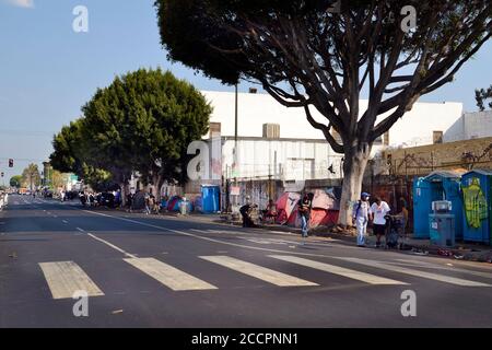 Los Angeles, CA, USA - August 22, 2020: Unidentified homeless people live in tents and emergency shelters on the street in times of the Covid 19 pande Stock Photo