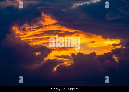 fiery window in the clouds at sunset Stock Photo