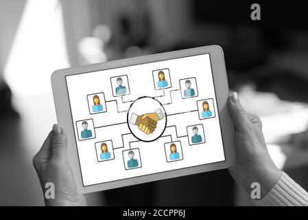 Collaboration concept shown on a tablet held by a woman Stock Photo