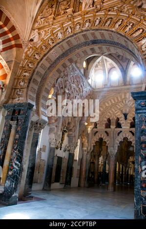 Horseshoe arch through to double tiered pink and white multi-foil arches at the Great Mosque-Cathedral of Cordoba, Spain. Stock Photo