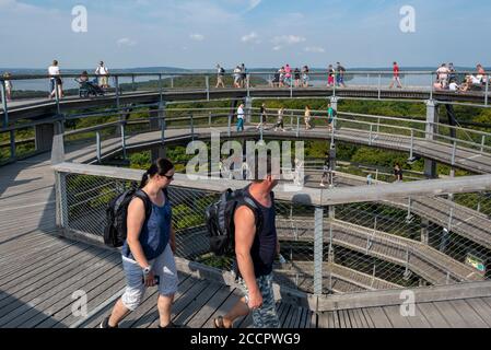 18 August 2020, Mecklenburg-Western Pomerania, Prora: Numerous tourists walk up the 40-meter-high observation tower. The tower was built around a copper beech. It has the shape of an eagle's nest and is located in the natural heritage centre in a beech forest on the island of Rügen. The treetop path is 1250 metres long in total. Photo: Stephan Schulz/dpa-Zentralbild/ZB Stock Photo
