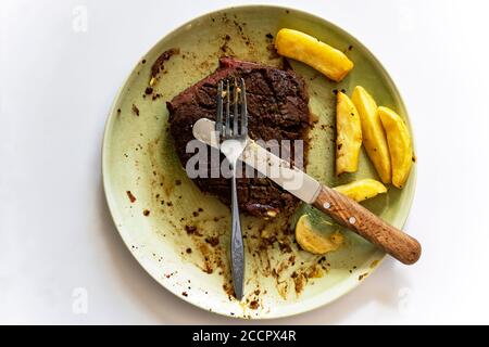 Steak and chips partly eaten Stock Photo