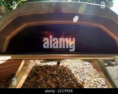 Fire wood burning in the oven. Italian pizzeria at home for high temperatures Stock Photo
