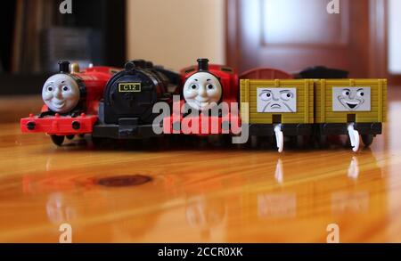 Photo of a Collection of battery powered trains troublesome trucks and box wagons from a Thomas the Tank Engine toy set Two James and C12 tank engine Stock Photo