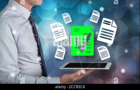Document validation concept above a tablet held by a man Stock Photo