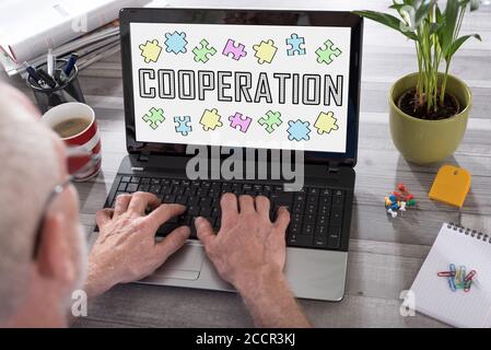 Cooperation concept shown on a laptop used by a man Stock Photo