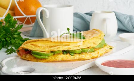 Trendy breakfast with quesadilla and eggs, trending food with omelet, cheese Stock Photo