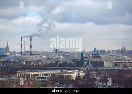 Smoke coming out of the chimneys of a thermal industrial station during winter in Moscow, Russia. Stock Photo