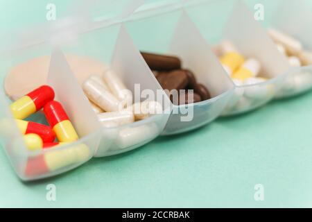 Seven day pill box with pills isolated Stock Photo