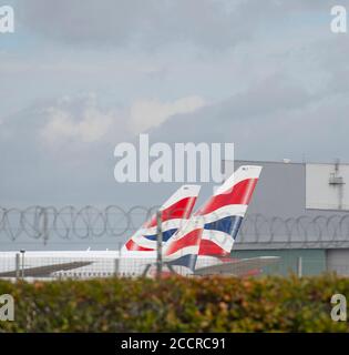 Heathrow Airport, London, UK. 24 August 2020. Tailfins of British Airways aircraft parked up at Heathrow airport. Credit: Malcolm Park/Alamy. Stock Photo