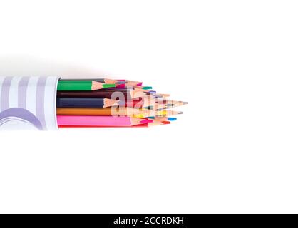 Multi-colored pencils in a tube on a white background. School supplies and stationery concept, pencil-case Stock Photo