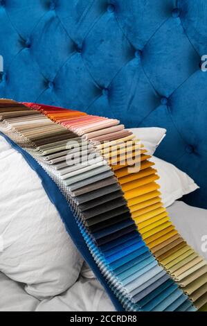 Luxury velvet samples in gradient colors placed on a pillow in a bed for the customers to select from Stock Photo