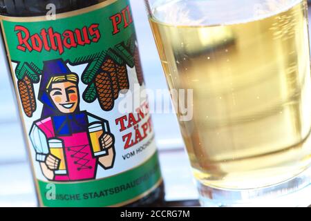 A bottle of German beer brand Rothaus Pils Tannenzapfle with beer glass Stock Photo