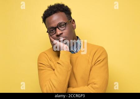 Unhappy frustrated young african man having puzzled expression Stock Photo