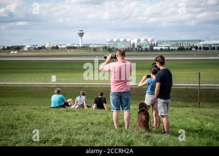 Munich, Germany. 24th Aug, 2020. Soccer fans watch the landing of the plane with the players of FC Bayern Munich at the airport in Munich. Credit: Matthias Balk/dpa/Alamy Live News Stock Photo