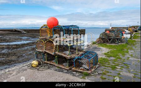 Lobster pots or creels piled on quayside, Port Seton harbour, Cockenzie, East Lothian, Scotland, UK Stock Photo