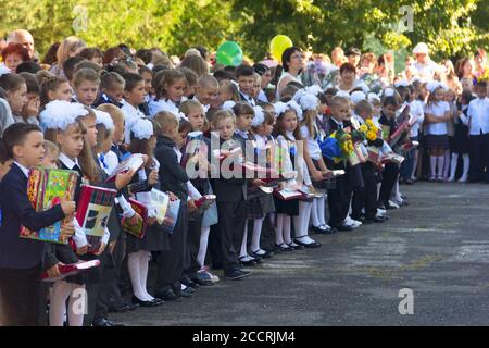 Adygea, Russia - September 1, 2017: children with bouquets of flowers enrolled in the first class with teachers and high school students on the school Stock Photo