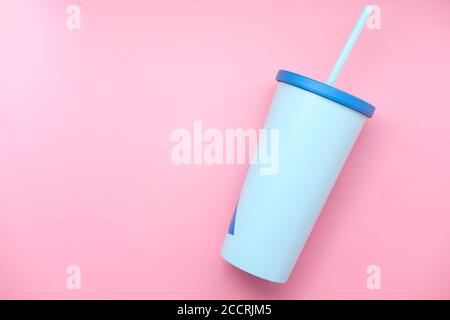 reusable eco coffee cup on pink background with copy space. Stock Photo