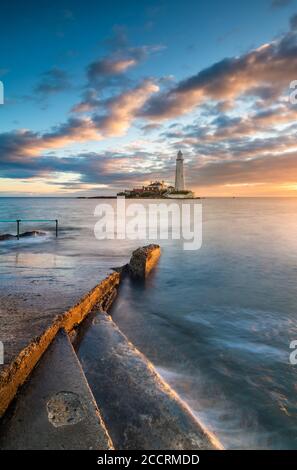 Standing on the steps looking out over the causeway with sun & sea at your feet for sunrise at St Marys Lighthouse Whitley Bay Northumberland Stock Photo