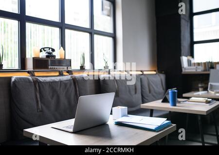 Laptops on desks in empty modern office. Stock Photo