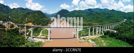 Beijing, China. 24th July, 2020. Aerial photo taken on July 24, 2020 shows the China-Laos Railway's Ban Ladhan Mekong River Super Major Bridge in Laos. Credit: Pan Longzhu/Xinhua/Alamy Live News Stock Photo