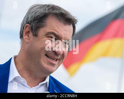 Munich, Germany. 24th Aug, 2020. Markus Söder (CSU), Prime Minister of Bavaria, stands on the tarmac in front of the German flag at Munich Airport. Credit: Peter Kneffel/dpa/Alamy Live News Stock Photo