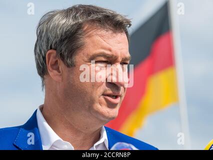 Munich, Germany. 24th Aug, 2020. Markus Söder (CSU), Prime Minister of Bavaria, stands on the tarmac in front of the German flag at Munich Airport. Credit: Peter Kneffel/dpa/Alamy Live News Stock Photo