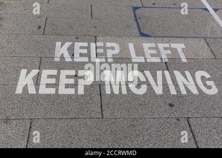 Keep Left Keep Moving pavement rule warning to keep distance during the Coronavirus crisis in London, England, UK Stock Photo