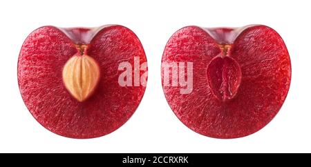 Isolated cherry halves. Fresh sweet cherry fruit cut in half with and without kernel isolated on white background Stock Photo