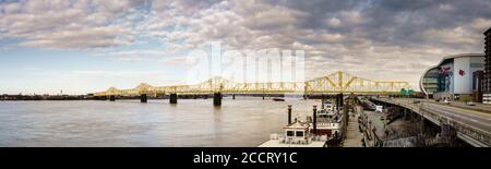 Louisvile, KY, February 23, 2020: George Rogers Clark Memorial Bridge aka Second Street Bridge across the Ohio River and KFC Yum Center in downtown Lo Stock Photo