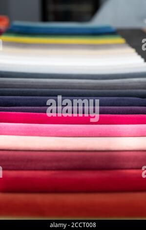 Folded soft luxury velvet samples placed in a row on a table Stock Photo