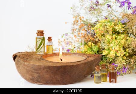 Organic essential aroma oils in glass bottles, medicine herbs and eco candle. Selective focus Stock Photo