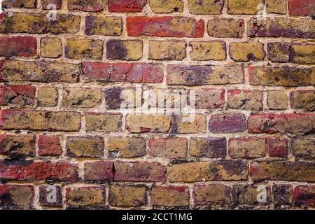 Ancient wall made with black and beige stones Stock Photo