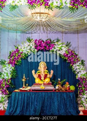 Lord Ganesha decorated with orchid flowers Stock Photo