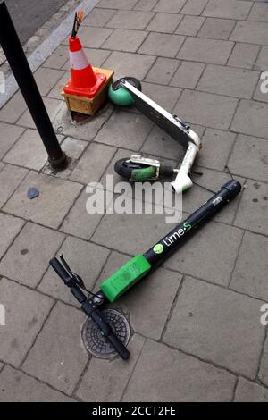 Cracow. Krakow. Poland.Damaged e-scooter tossed on the sidewalk with broken steering column. Stock Photo