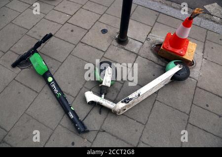 Cracow. Krakow. Poland.Damaged e-scooter tossed on the sidewalk with broken steering column. Stock Photo