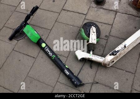 Cracow. Krakow. Poland.Damaged e-scooter tossed on the sidewalk with broken steering column. Stock Photo