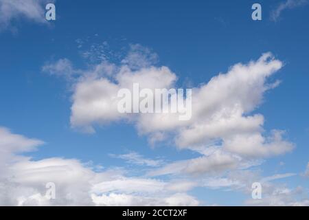 fluffy white clouds against a blue sky. background. Stock Photo