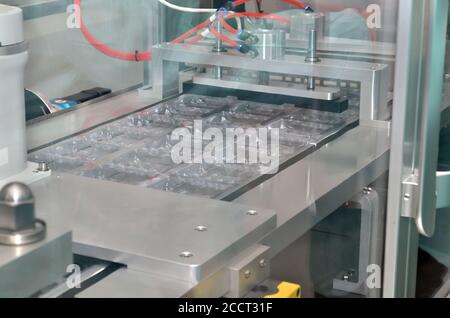 Pharmaceutical industry line for sealing ampoules in plastic packaging Stock Photo