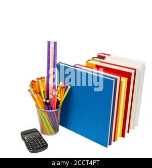 Vertical shot of a group of school supplies: books, calculator, and a wire pencil holder full of pencils and a ruler.  White background.  Copy space. Stock Photo