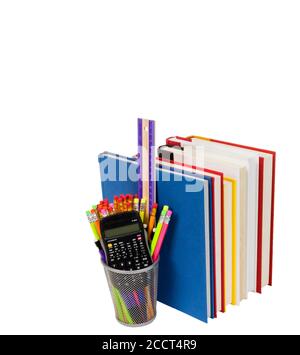 Vertical shot of a row of colorful books with the pages facing out and a wire pencil holder full of pencils, a ruler, and a calculator.  White backgro Stock Photo