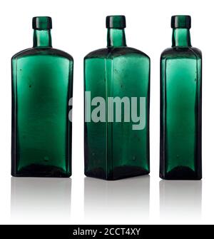 Old empty bottles isolated on a white background. Dusty bottles from color glass. Stock Photo