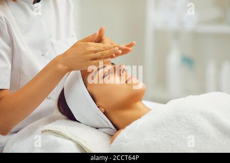 Facial massage.Beautician makes anti-age massage to a woman in a beauty salon Stock Photo