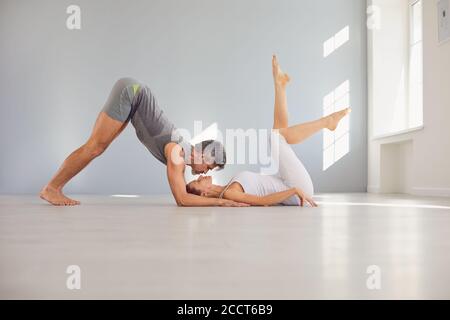 Sporty couple practicing partner yoga Stock Photo