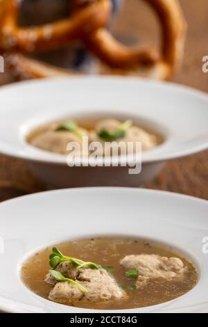 bavarian meat dumpling in broth on wood Stock Photo