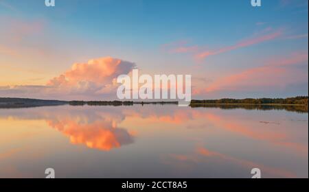 Summer evening landscape. Colorful dusk clouds wallpaper. Sunset colors reflection on lake water surface. Belarus nature Stock Photo