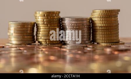 Stacks of euro coins with blurred coins in the foreground Stock Photo